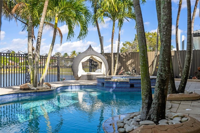 view of swimming pool featuring an in ground hot tub