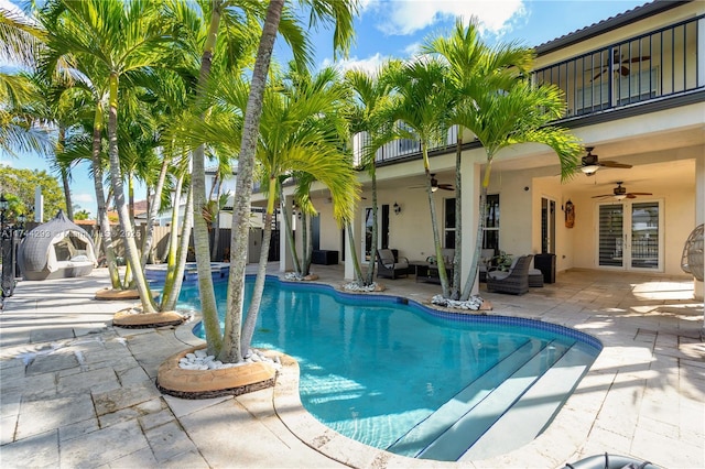 view of pool with a patio and ceiling fan