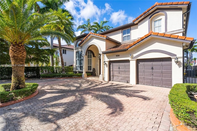 mediterranean / spanish house with a garage