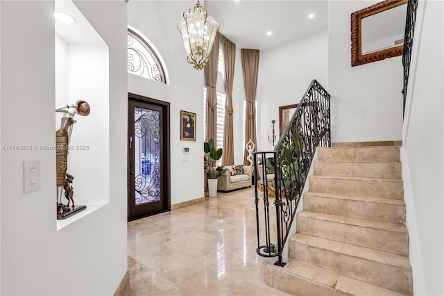 foyer featuring a chandelier and a high ceiling