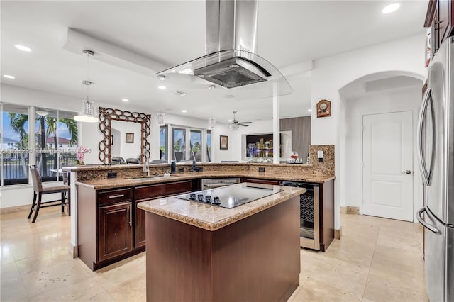 kitchen featuring wine cooler, island range hood, stainless steel refrigerator, kitchen peninsula, and pendant lighting