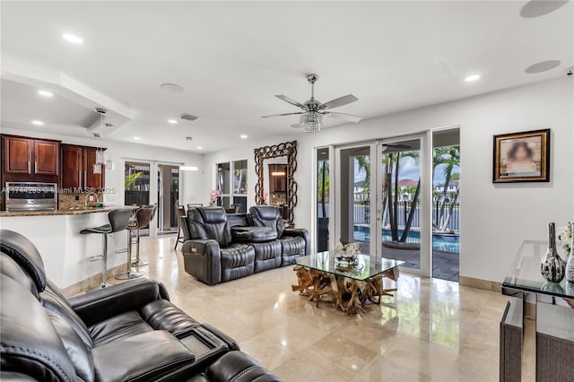 living room featuring ceiling fan and french doors