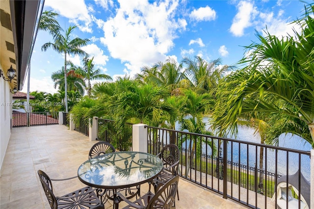 balcony with a water view and a patio area