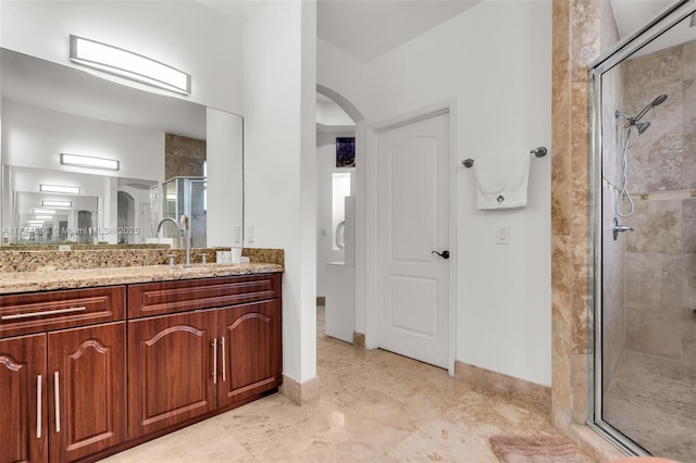 bathroom with vanity and a shower with door