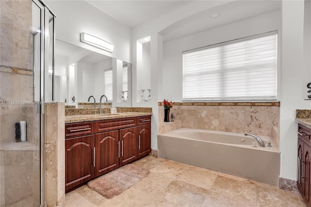 bathroom featuring vanity and shower with separate bathtub