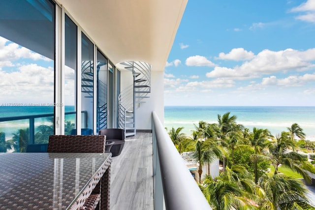 balcony with a beach view and a water view