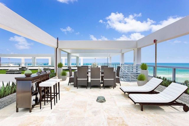 view of patio / terrace with a bar and a water view