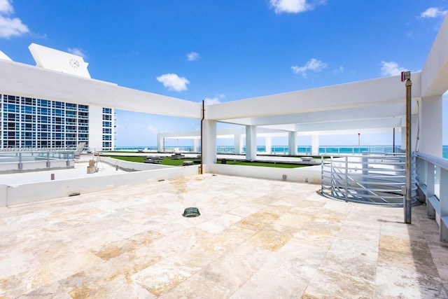 view of patio with a water view