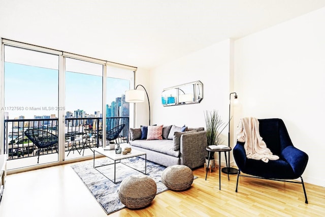 living room with wood-type flooring and floor to ceiling windows