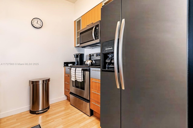 kitchen featuring stainless steel appliances and light hardwood / wood-style flooring