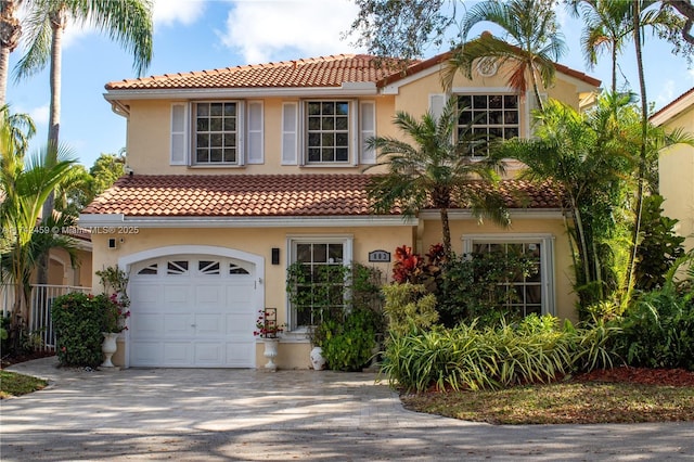 mediterranean / spanish home with a garage