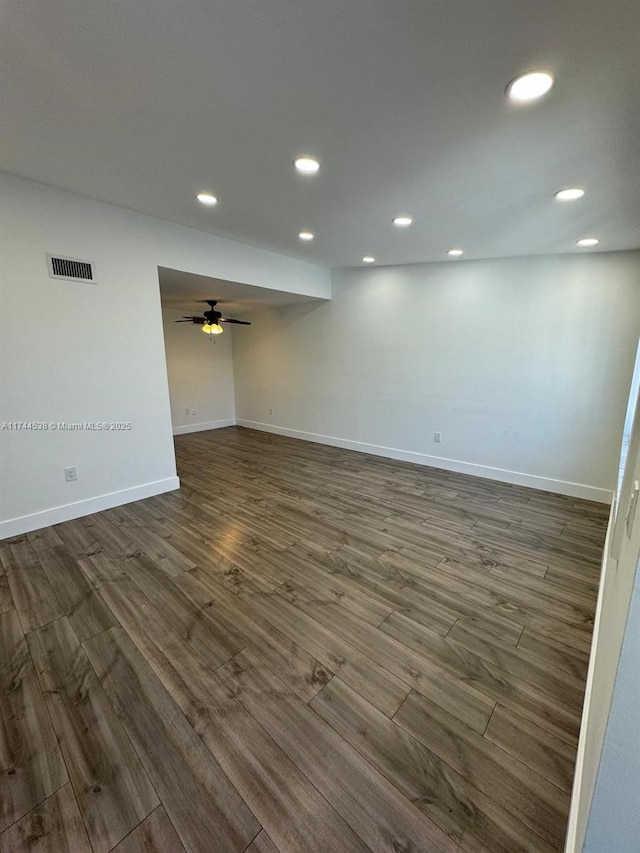 spare room with ceiling fan and dark hardwood / wood-style floors