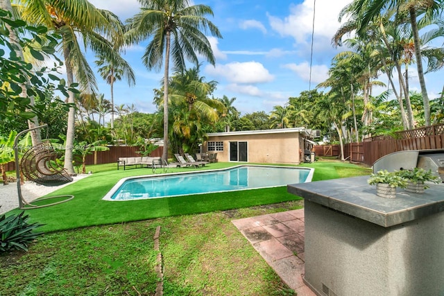 view of swimming pool featuring a lawn and a patio area