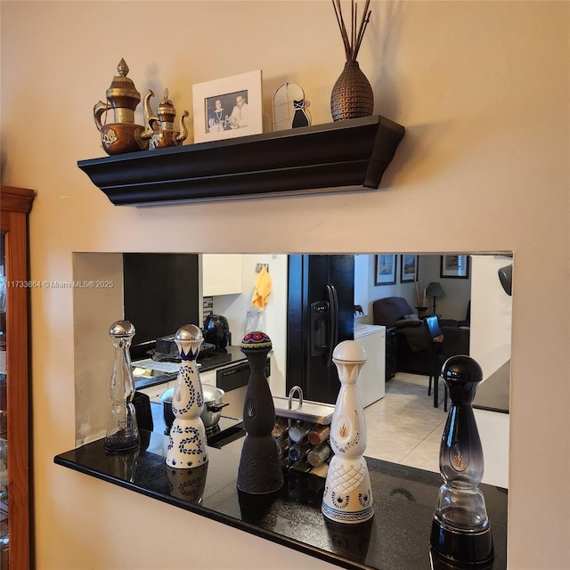 interior details with black refrigerator with ice dispenser