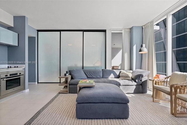 living room with light tile patterned floors and floor to ceiling windows