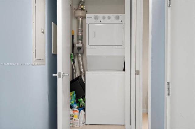 clothes washing area with stacked washer / drying machine