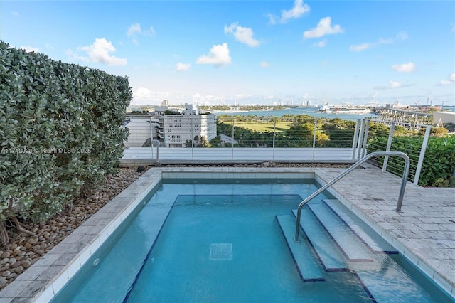 view of pool featuring a water view