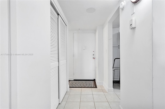 corridor with light tile patterned flooring