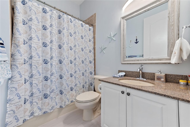 bathroom with a shower with curtain, vanity, and toilet