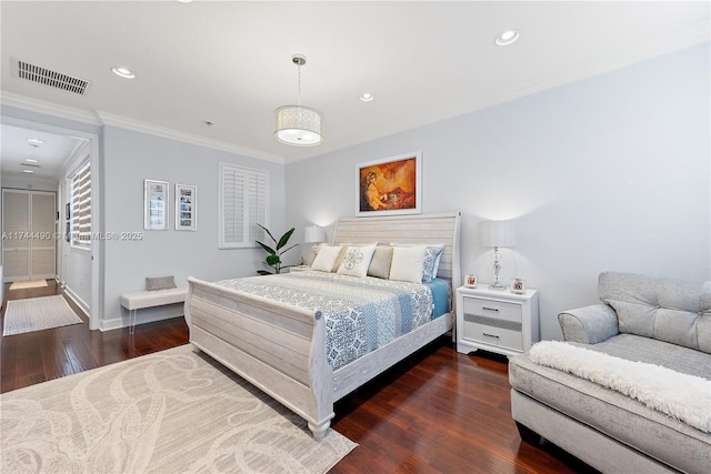 bedroom with crown molding and dark hardwood / wood-style flooring