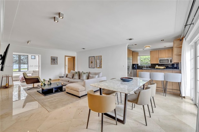 dining space with crown molding