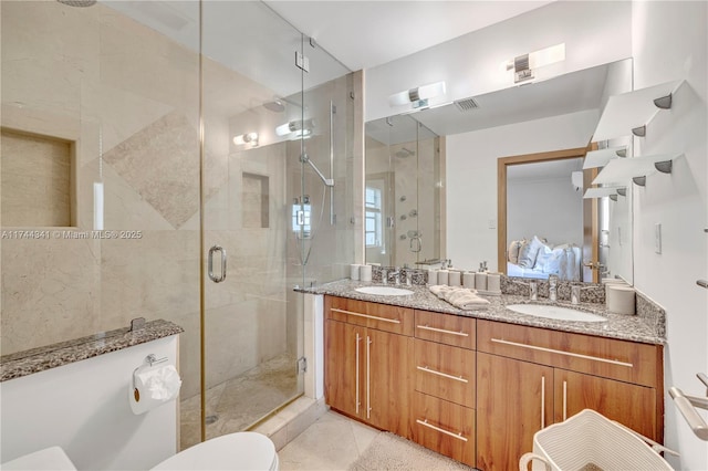 bathroom with vanity and a shower with shower door