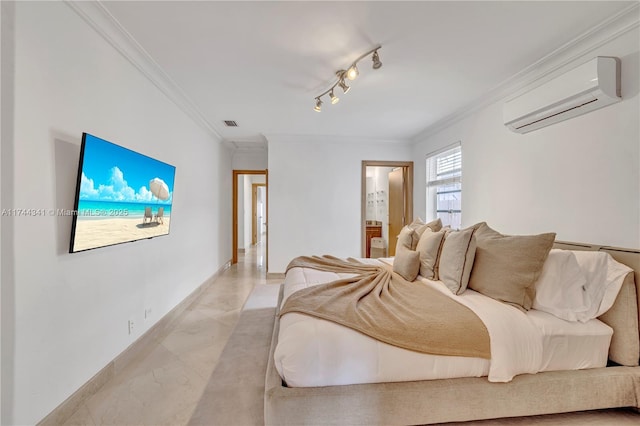 bedroom featuring crown molding, rail lighting, an AC wall unit, and ensuite bathroom