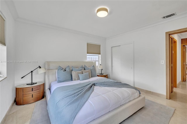 bedroom with ornamental molding and a closet