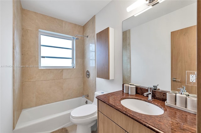 full bathroom with tiled shower / bath, vanity, and toilet