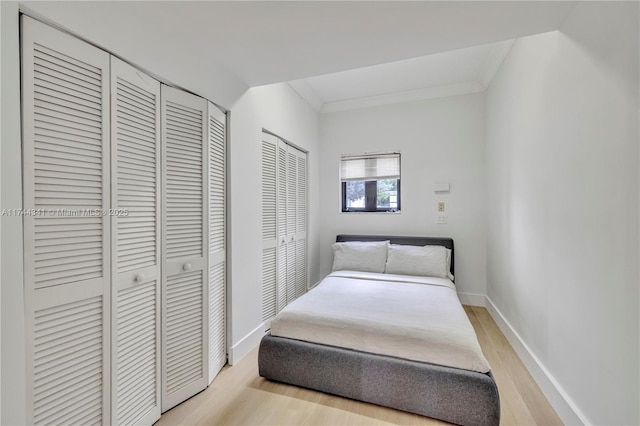 bedroom featuring crown molding and light hardwood / wood-style flooring