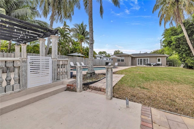 view of patio / terrace with a fenced in pool, french doors, and a pergola