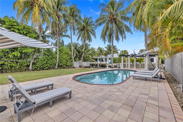 view of swimming pool featuring a pergola, a yard, and a patio area