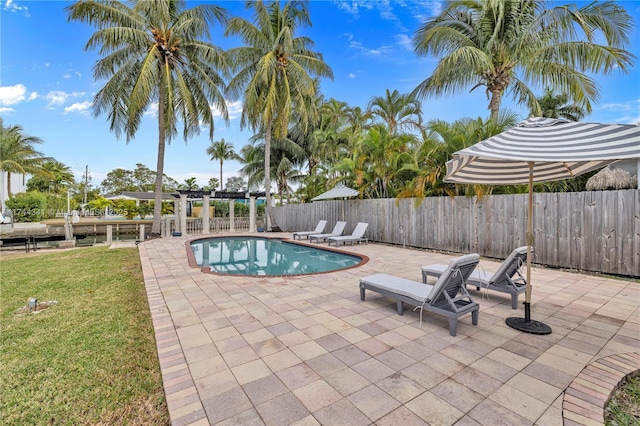 view of pool featuring a lawn, a patio area, and a pergola