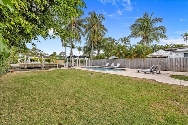 view of yard featuring a fenced in pool, a patio, and a pergola