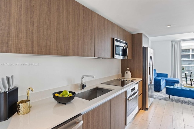 1600 SW 1st Ave Unit 704, Miami, FL 33129 - kitchen with stainless steel appliances, light countertops, modern cabinets, and a sink