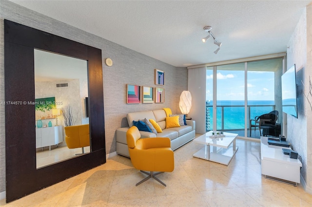 living room with a wall of windows and a textured ceiling