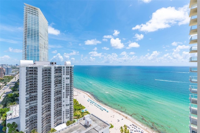 bird's eye view featuring a water view and a beach view