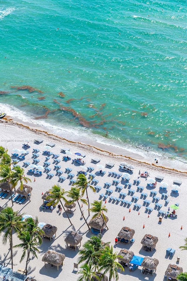 birds eye view of property featuring a view of the beach and a water view