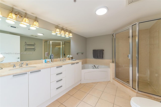 full bathroom with tile patterned floors, toilet, independent shower and bath, and vanity