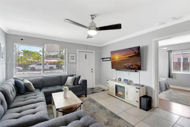 tiled living room featuring ornamental molding and ceiling fan