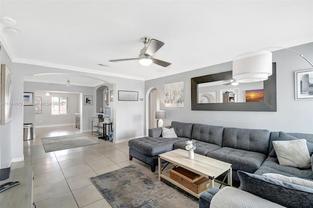 tiled living room with crown molding and ceiling fan