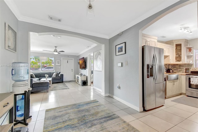 corridor featuring ornamental molding and light tile patterned floors