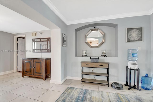 corridor featuring ornamental molding and light tile patterned floors