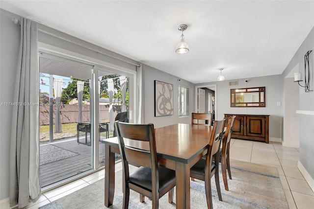 dining space featuring light tile patterned floors