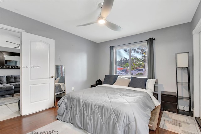 bedroom with wood-type flooring and ceiling fan