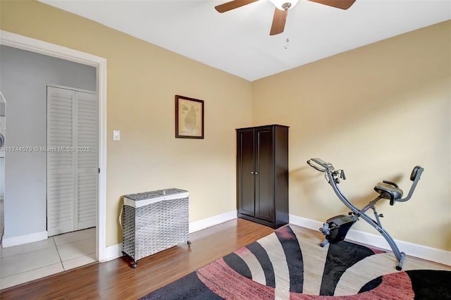 exercise room featuring ceiling fan and light hardwood / wood-style floors