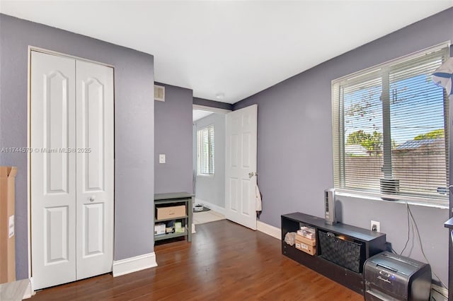 interior space featuring dark hardwood / wood-style floors and a closet