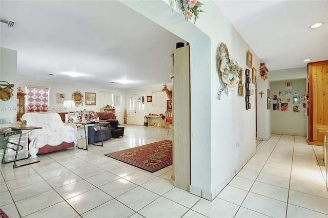 hall with light tile patterned floors