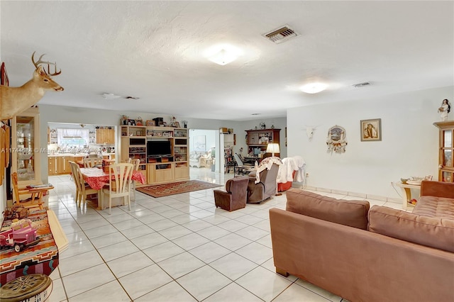 tiled living room with a textured ceiling