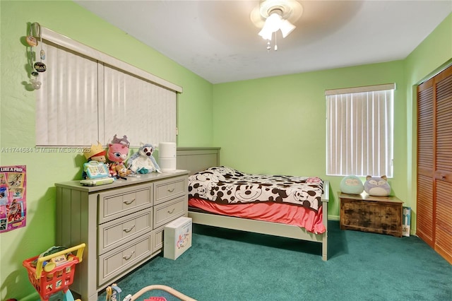 carpeted bedroom with a closet and ceiling fan